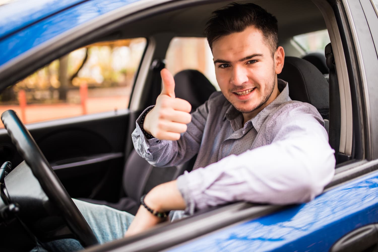 happy-smiling-man-sitting-inside-car-showing-thumbs-up-handsome-guy-excited-about-his-new-vehicle-positive-face-expression-1.jpg